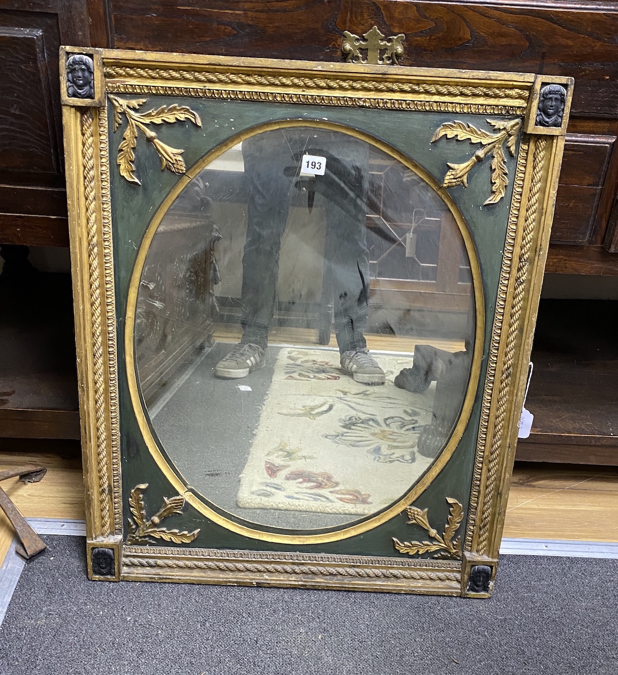 A 19th century French giltwood and composition wall mirror with oval plate width 64cms, height 80cms.